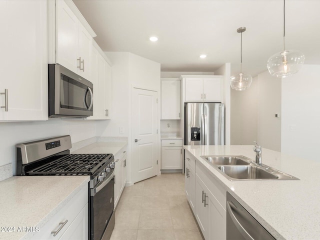 kitchen with white cabinetry, stainless steel appliances, sink, and pendant lighting