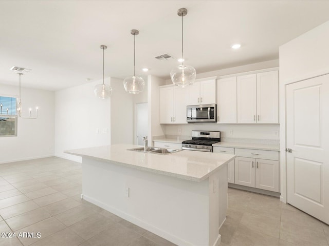 kitchen with white cabinetry, stainless steel appliances, sink, and an island with sink