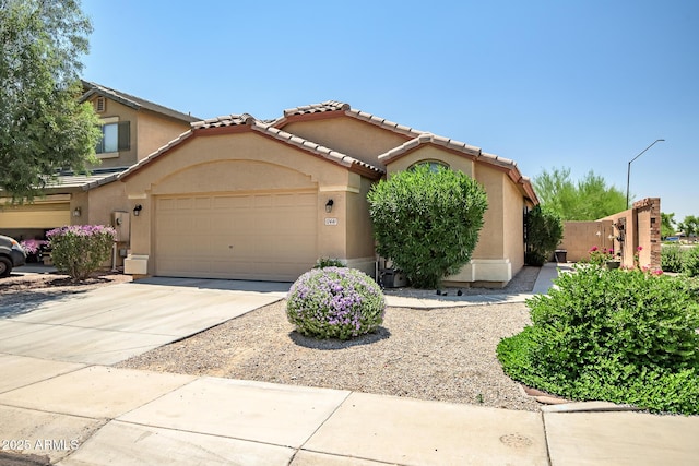 12441 W Windsor Blvd, Litchfield Park, AZ 85340 - mediterranean / spanish home with stucco siding, a garage, concrete driveway, and a tiled roof