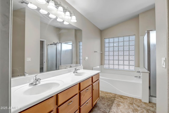12441 W Windsor Blvd, Litchfield Park, AZ 85340 - full bathroom featuring lofted ceiling, a garden tub, double vanity, and a stall shower