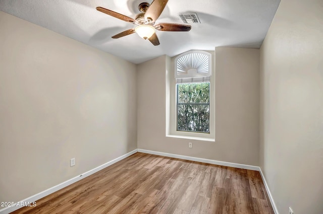 12441 W Windsor Blvd, Litchfield Park, AZ 85340 - unfurnished room featuring ceiling fan, wood finished floors, baseboards, and lofted ceiling