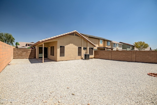 12441 W Windsor Blvd, Litchfield Park, AZ 85340 - rear view of house featuring stucco siding, a fenced backyard, a tile roof, and a patio area
