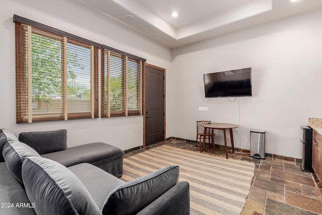 living room with a tray ceiling