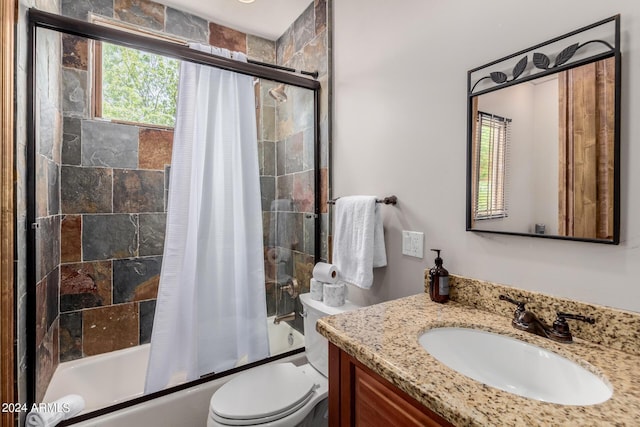 full bathroom featuring combined bath / shower with glass door, vanity, toilet, and a wealth of natural light