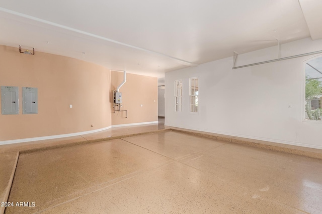 garage featuring electric panel and water heater