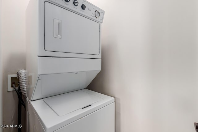 washroom featuring stacked washer and clothes dryer