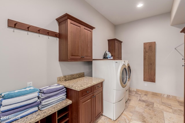 washroom featuring washer and clothes dryer and cabinets