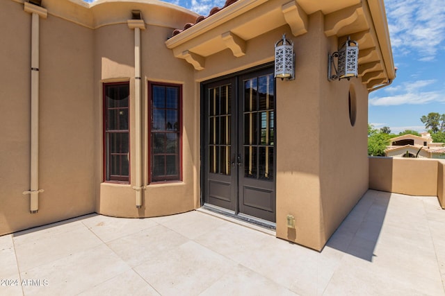 property entrance featuring french doors and a patio