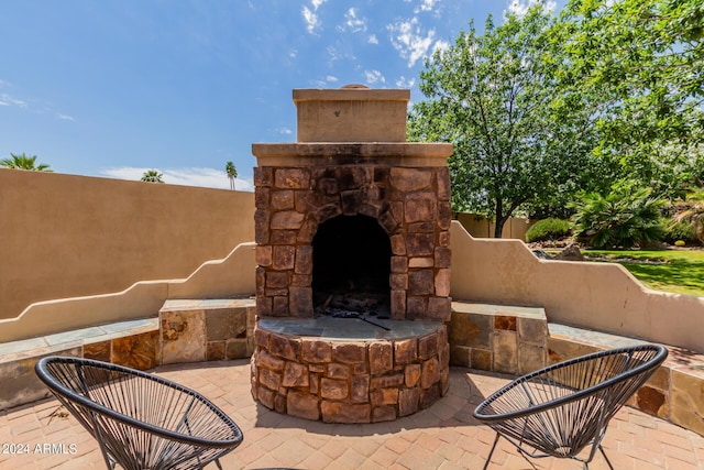 view of patio with an outdoor stone fireplace