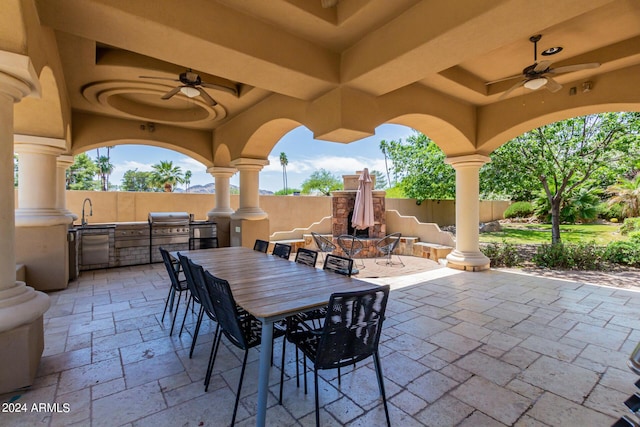 view of patio featuring ceiling fan, exterior kitchen, sink, and grilling area