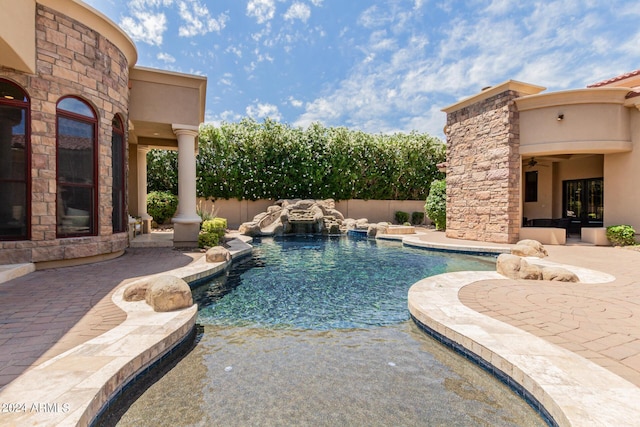 view of swimming pool with a patio and pool water feature