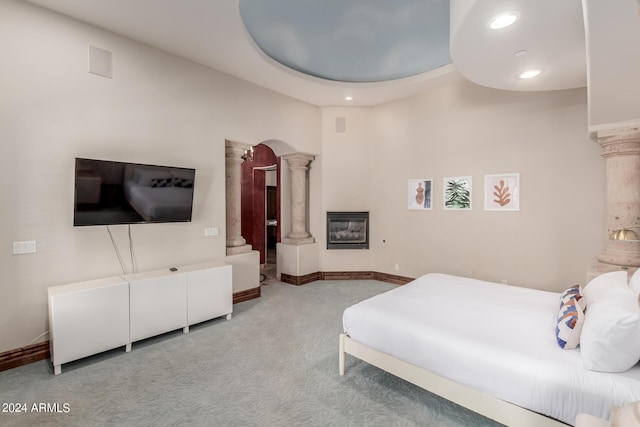 bedroom featuring carpet and decorative columns