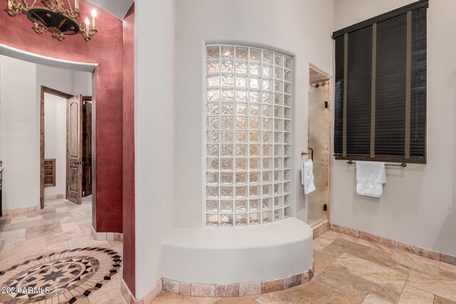 bathroom with shower with separate bathtub