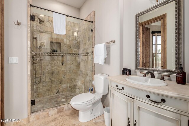 bathroom with vanity, a shower with shower door, and toilet