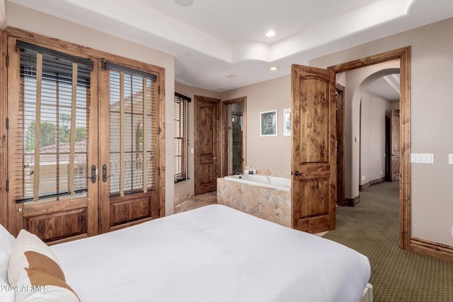 bedroom with carpet, a raised ceiling, and french doors