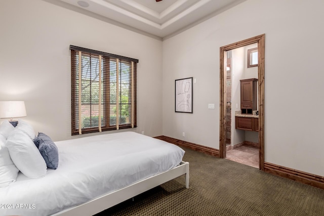 carpeted bedroom featuring ensuite bathroom