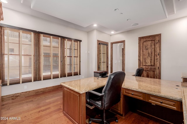 office area with built in desk and light hardwood / wood-style flooring