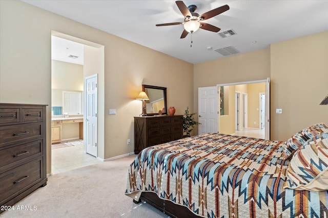 bedroom featuring connected bathroom, ceiling fan, and light colored carpet