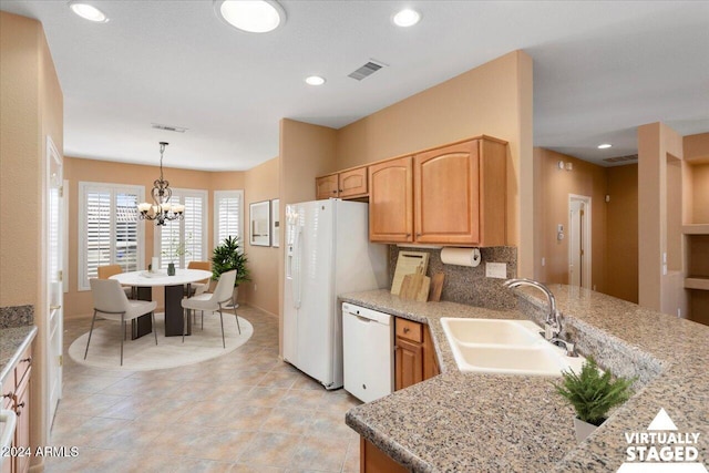 kitchen with pendant lighting, recessed lighting, visible vents, a sink, and white appliances