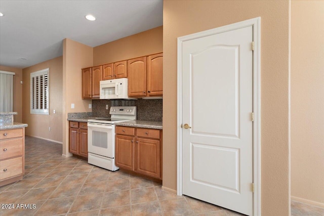 kitchen with white appliances, baseboards, decorative backsplash, and light tile patterned floors