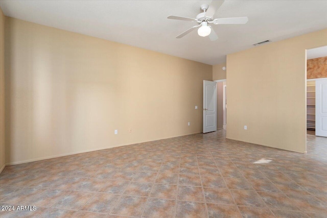 spare room with visible vents and a ceiling fan