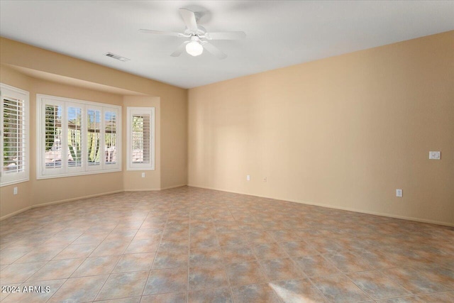 unfurnished room featuring light tile patterned floors, a ceiling fan, visible vents, and a healthy amount of sunlight