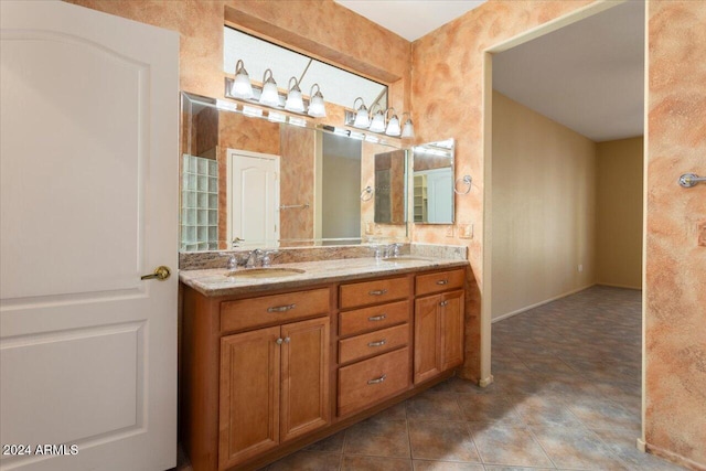 bathroom with double vanity, a sink, and tile patterned floors