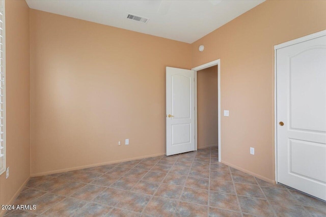 unfurnished bedroom featuring visible vents and baseboards