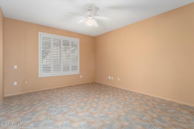 empty room featuring baseboards and a ceiling fan