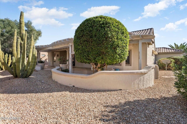 exterior space with a tile roof, a patio, and stucco siding