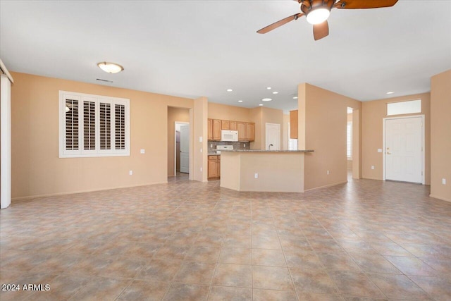 unfurnished living room with light tile patterned flooring, ceiling fan, baseboards, and recessed lighting