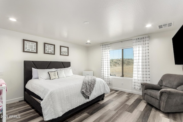 bedroom with hardwood / wood-style floors