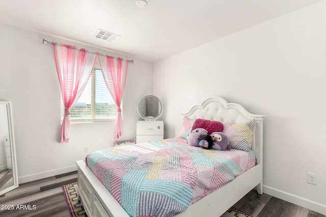 bedroom with dark hardwood / wood-style floors