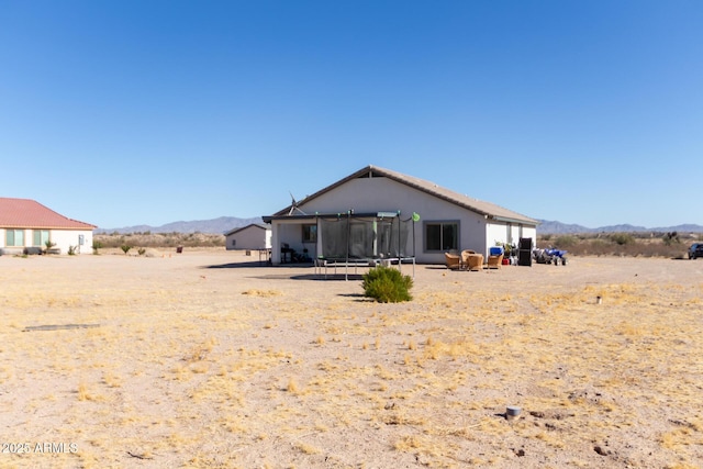 rear view of property with a mountain view and a patio