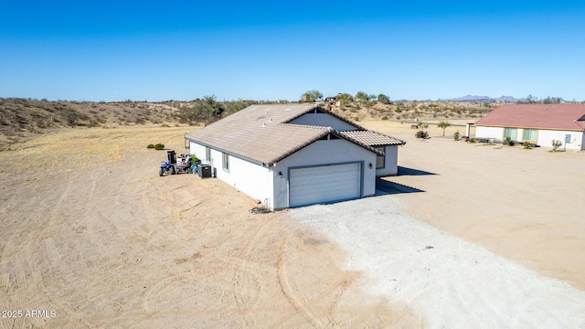 view of front of house featuring central AC and a garage