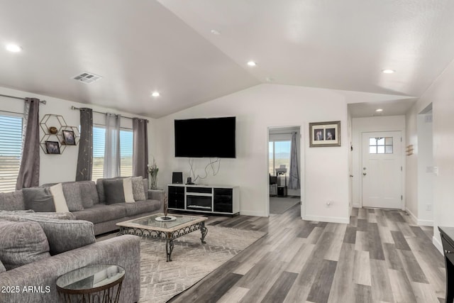 living room featuring lofted ceiling and light wood-type flooring