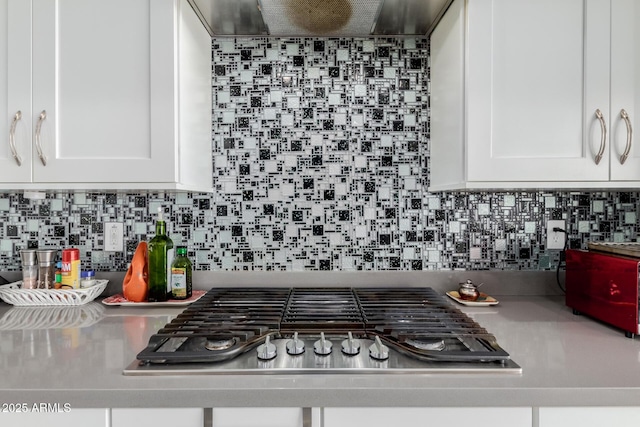 kitchen with stainless steel gas stovetop, white cabinetry, and tasteful backsplash