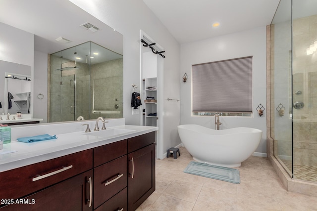 bathroom with tile patterned floors, vanity, and independent shower and bath