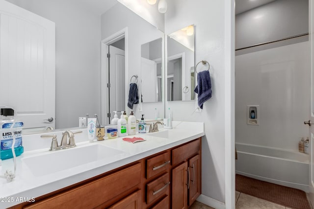 bathroom with tile patterned flooring, vanity, and washtub / shower combination