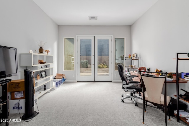 home office with french doors and light carpet