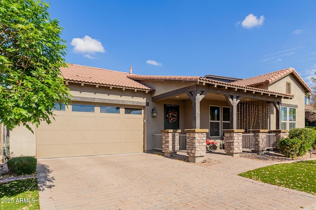 view of front of home with a garage and a porch