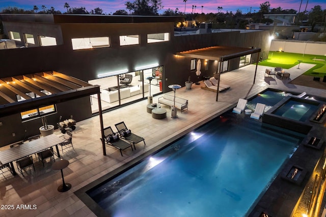 view of pool featuring a patio area, a pool with connected hot tub, and fence