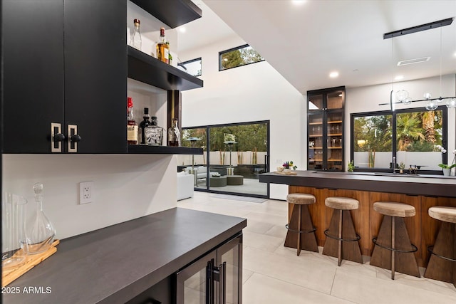 bar featuring visible vents, beverage cooler, recessed lighting, light tile patterned flooring, and bar