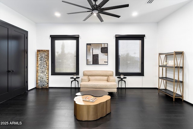 living area with recessed lighting, wood finished floors, baseboards, and ceiling fan