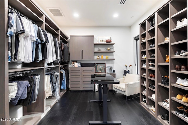 walk in closet with visible vents and dark wood finished floors