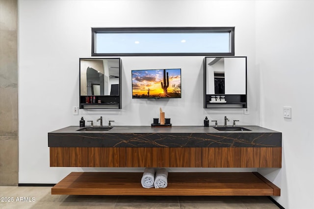 interior space with double vanity, a wealth of natural light, and a sink