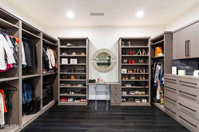 walk in closet with visible vents and dark wood-style flooring