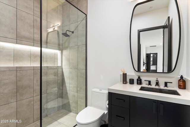 bathroom with a stall shower, toilet, and vanity