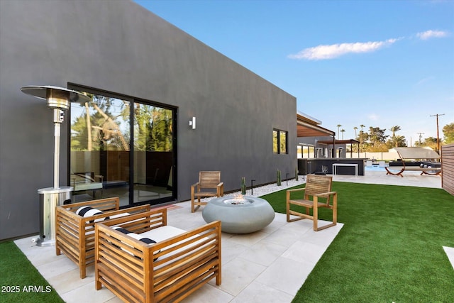 view of patio / terrace featuring an outdoor living space with a fire pit