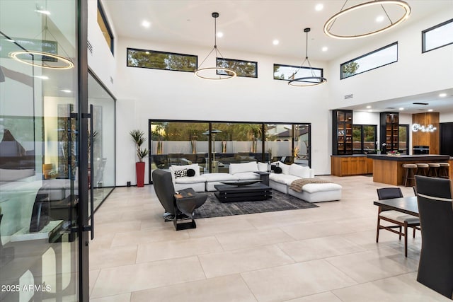 living room with light tile patterned floors, visible vents, a healthy amount of sunlight, and recessed lighting